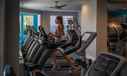 woman on treadmill in fitness center
